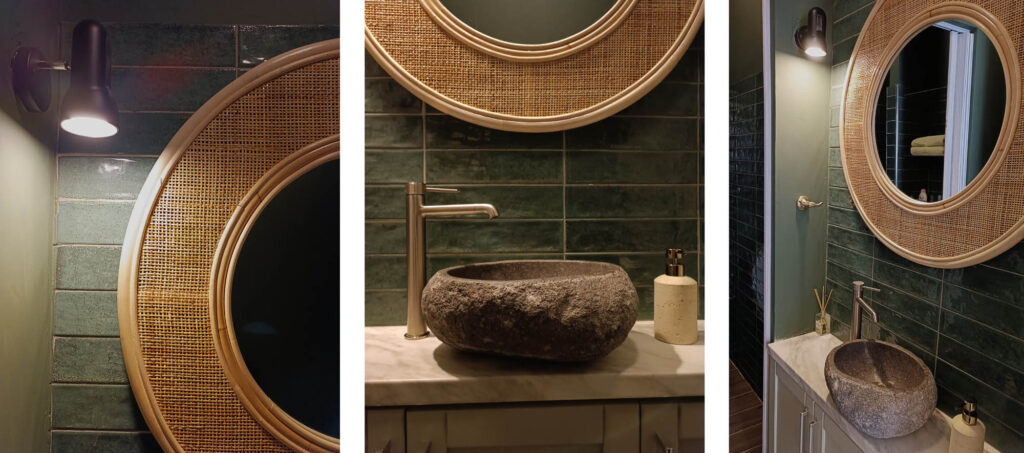 Φωτογραφία από τον προθάλαμο του χώρου υγιεινής του κέντρου ευεξίας Nature Thai Massage. Οι τοίχοι είναι καλυμμένοι με έντονο μακρόστενο πράσινο πλακάκι, υπάρχει στρόγγυλος καθρέφτης με πλαίσιο από ρατάν, ο νιπτήρας είναι επικαθήμενος και από φυσικό πέτρωμα.